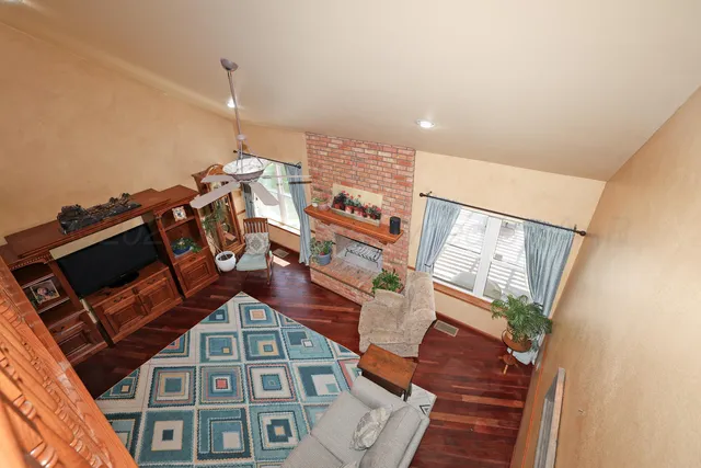a view of a dining room with furniture and chandelier
