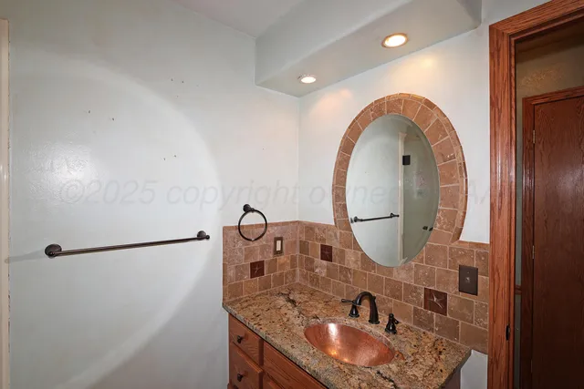 a bathroom with a double vanity sink mirror and toilet