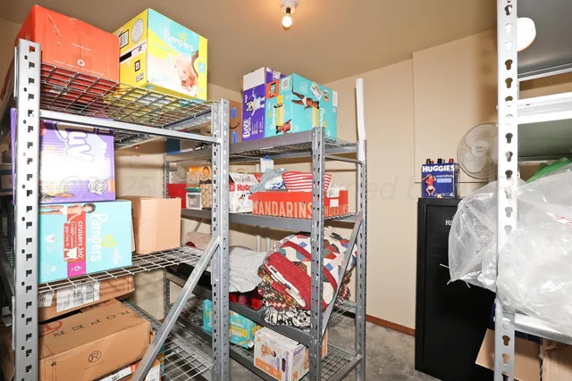 a view of a table and chairs in back yard of the house