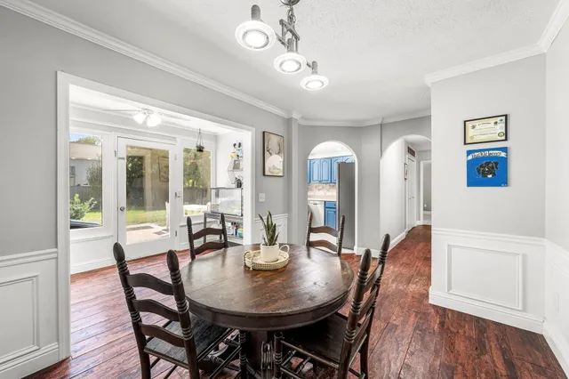 a view of a dining room with furniture wooden floor and chandelier