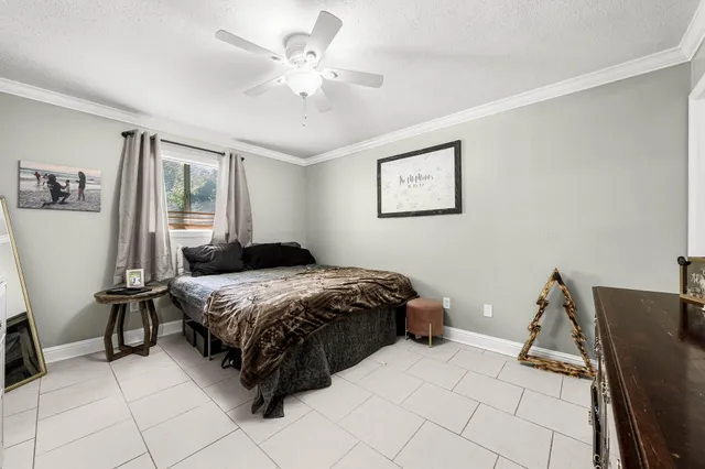 a bedroom with a bed and a chair