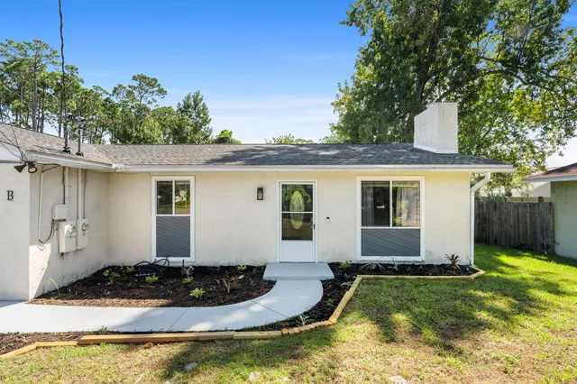 a front view of house with yard outdoor seating and garage
