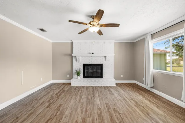 a kitchen with granite countertop a refrigerator a sink a stove a microwave and island