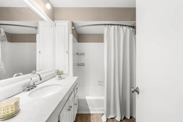 a view of a livingroom with a ceiling fan and wooden floor