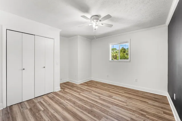 a view of an empty room with wooden floor