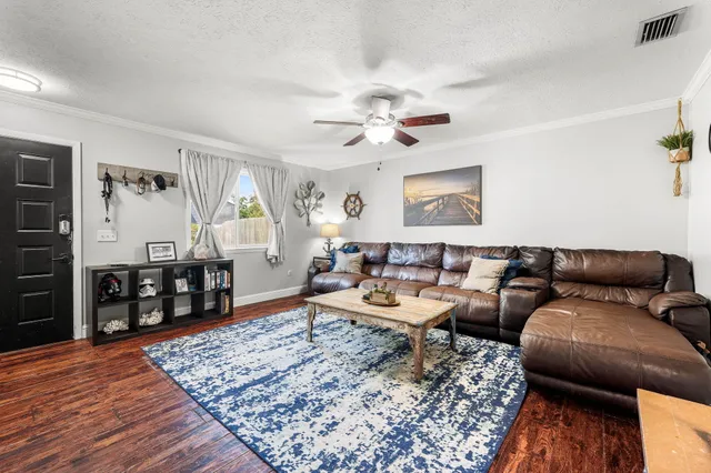 a living room with furniture and wooden floor