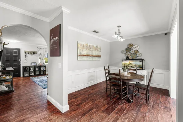 a view of a dining room with furniture and wooden floor