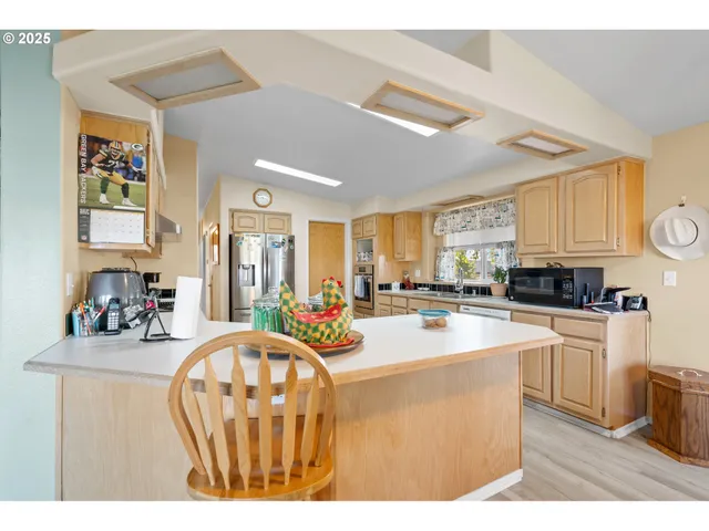 a view of a dining room with furniture and a chandelier