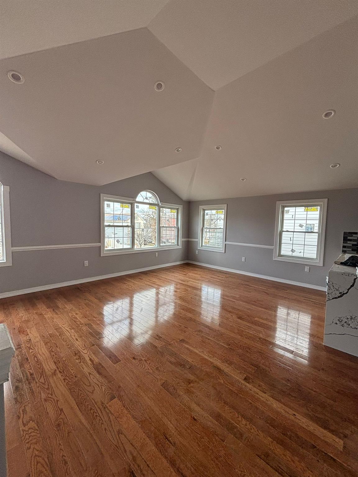 175-04 145th Drive Queens, NY 11434 - Photo 3 of 10 an empty room with wooden floor and windows