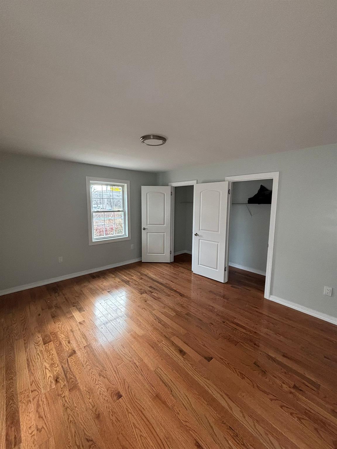 175-04 145th Drive Queens, NY 11434 - Photo 6 of 10 a view of empty room with wooden floor and window