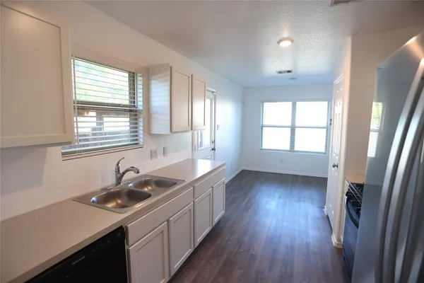 a kitchen with sink a window and stainless steel appliances