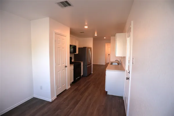 a view of a kitchen cabinets and wooden floor