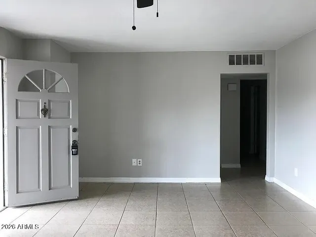 a view of a hallway to rooms