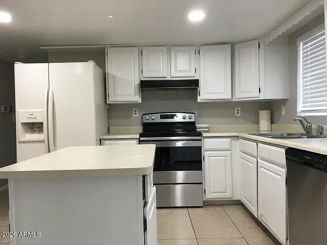 a kitchen with a sink a stove and refrigerator