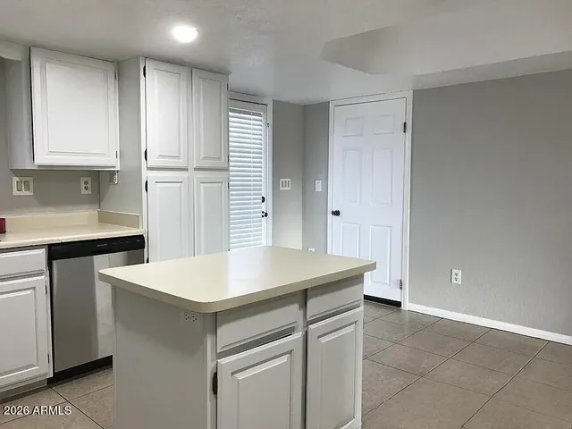 a kitchen that has a sink and a stove in it