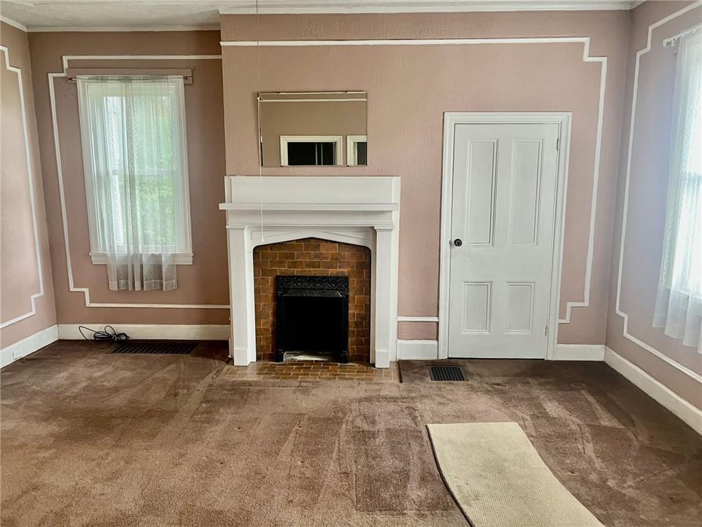 992 McCoy Road McKees Rocks, PA 15136 - Photo 4 of 9 a view of empty room with a fireplace and window