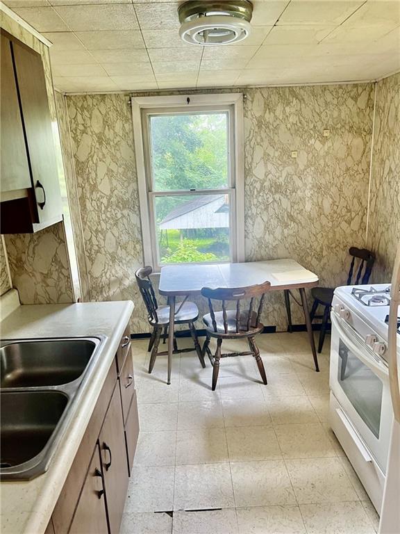 992 McCoy Road McKees Rocks, PA 15136 - Photo 5 of 9 a kitchen with a stove and white cabinets