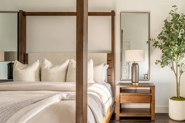 a bed sitting in a bedroom next to a window