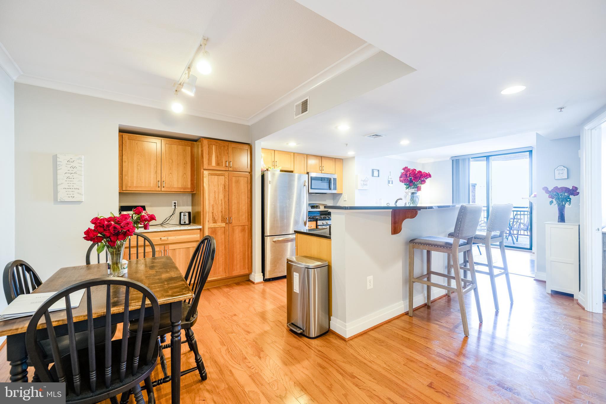a living room with dining room and wooden floor
