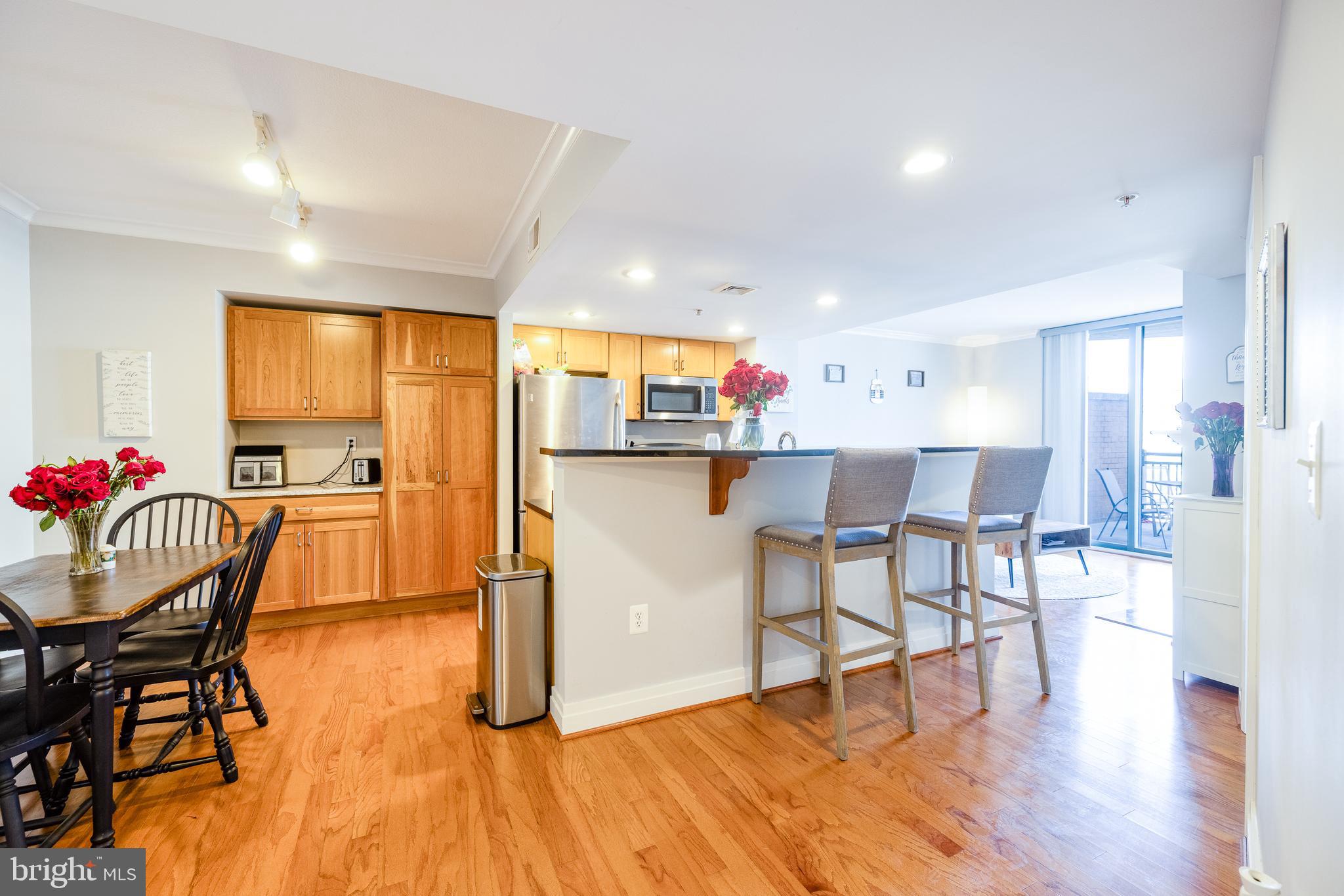 414 Water Street, Unit 1108 Baltimore, MD 21202 - Photo 11 of 36 a dining room with furniture and kitchen view