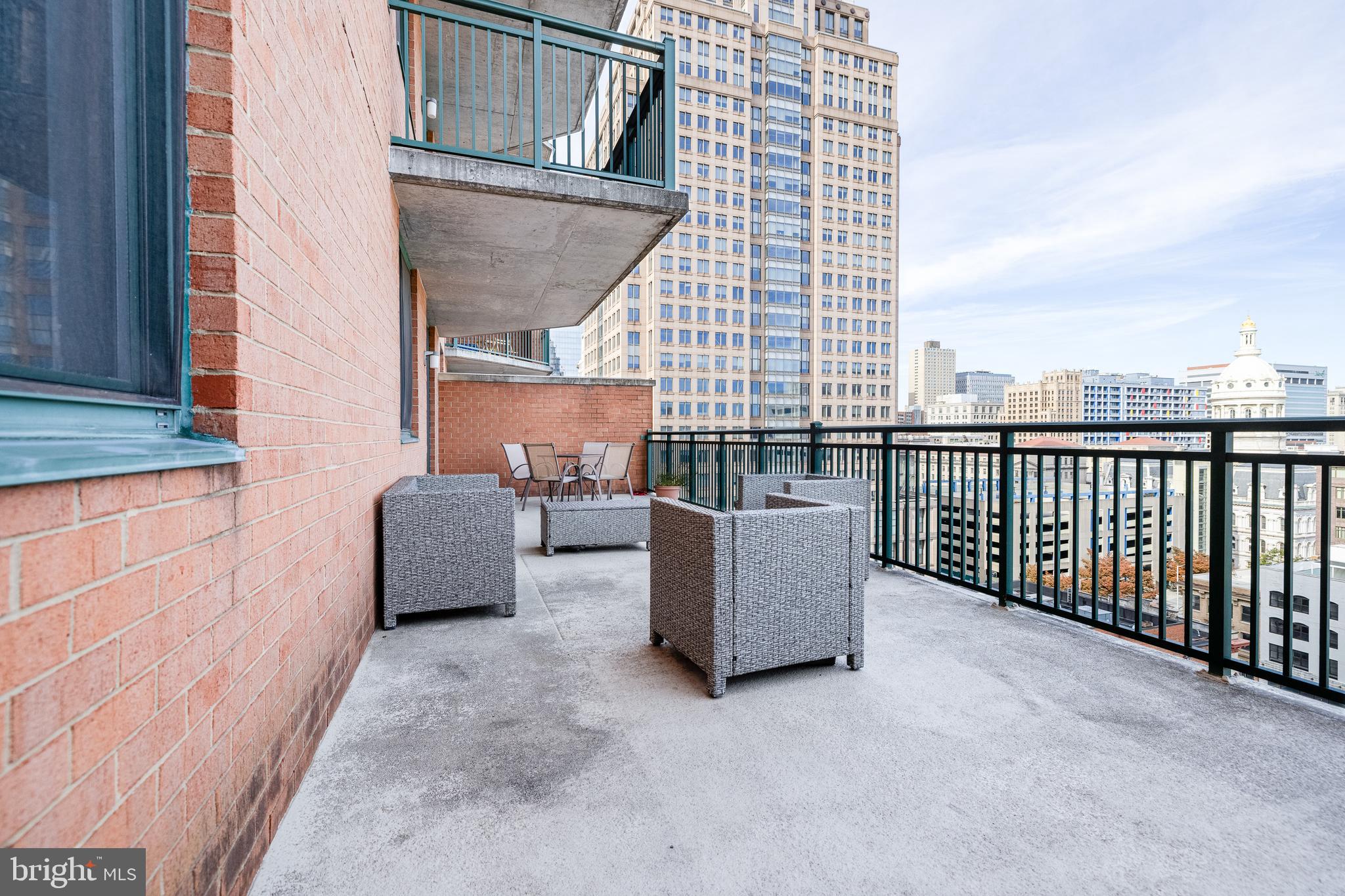 414 Water Street, Unit 1108 Baltimore, MD 21202 - Photo 13 of 36 a view of a terrace with couches and potted plants