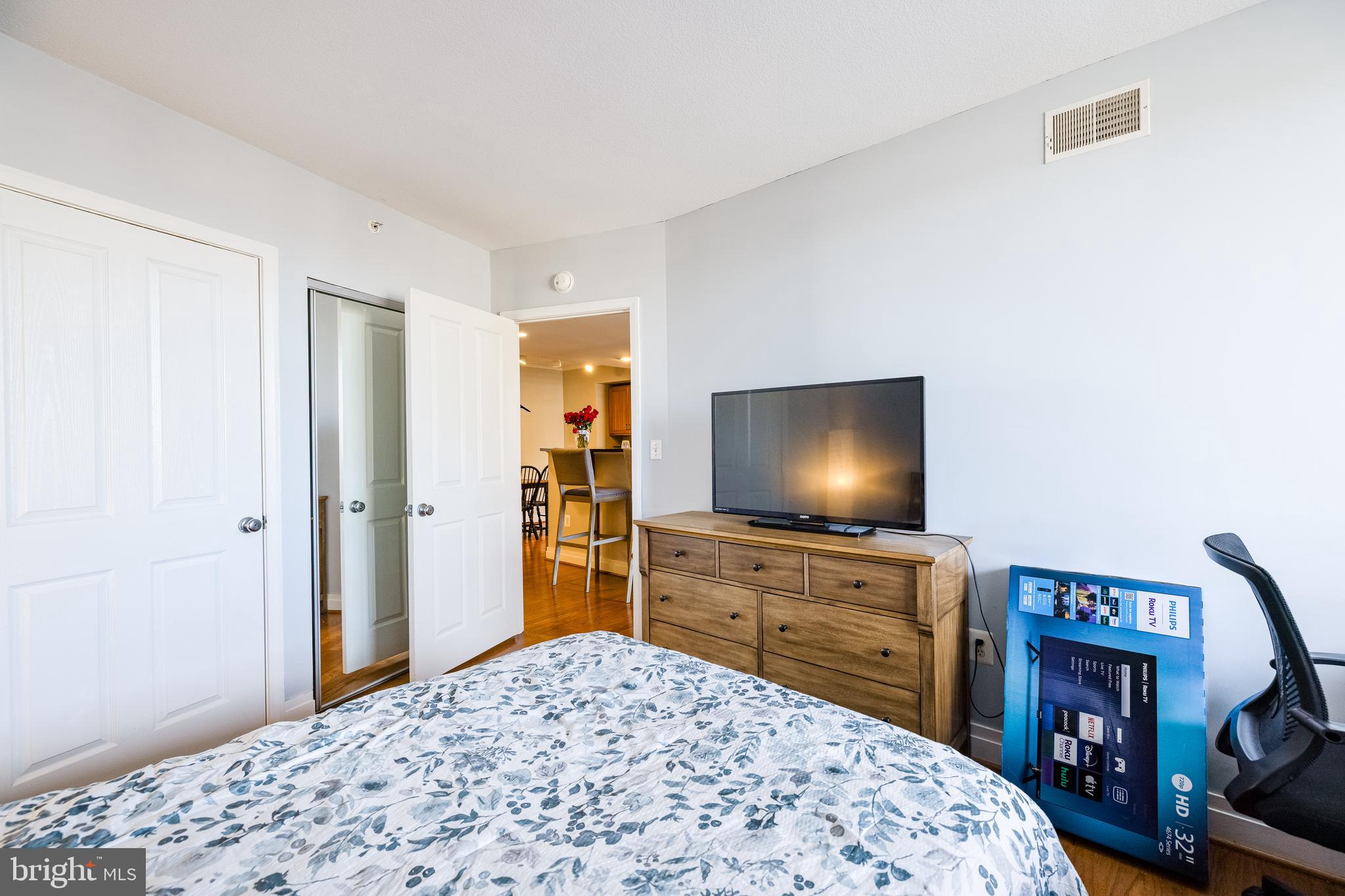 414 Water Street, Unit 1108 Baltimore, MD 21202 - Photo 18 of 36 a bedroom with a bed and a flat screen tv