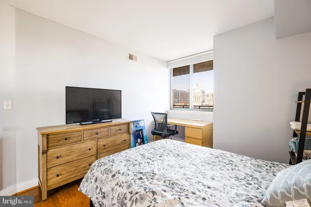 a bathroom with a granite countertop sink a toilet a mirror and shower