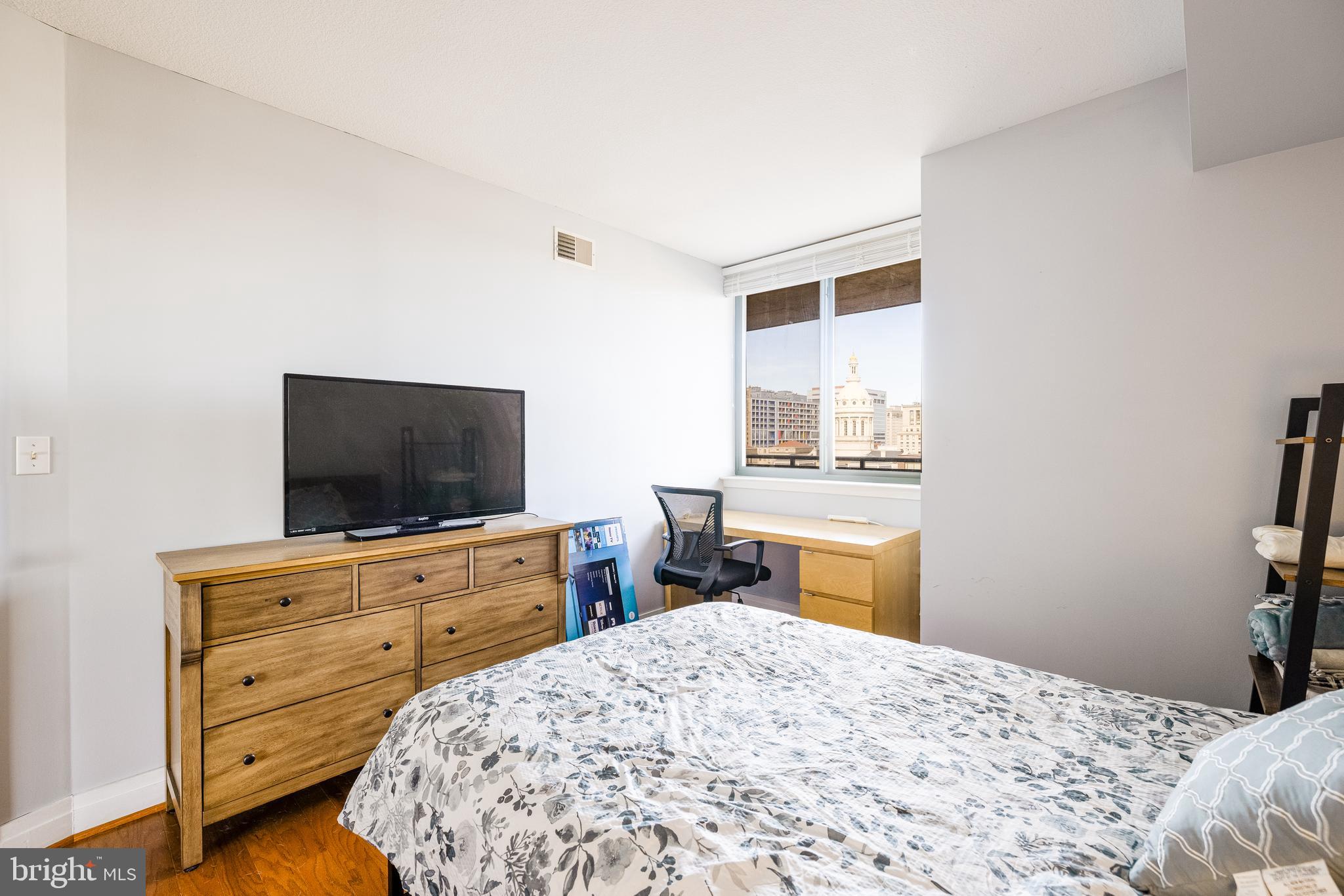 414 Water Street, Unit 1108 Baltimore, MD 21202 - Photo 19 of 36 a bedroom with a bed and a flat screen tv