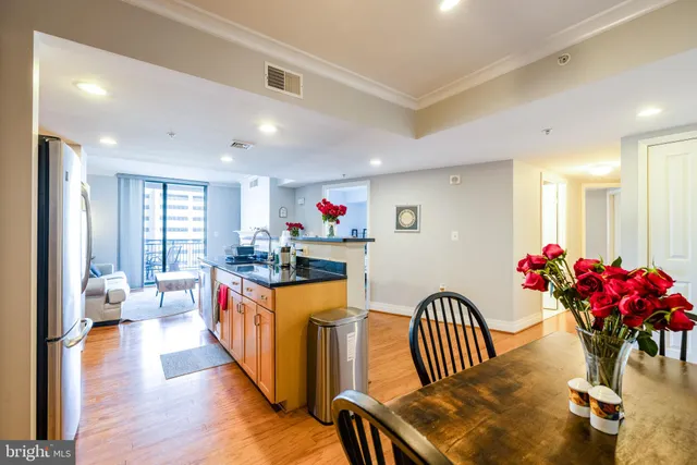 a very nice looking dining room with wooden floor and furniture