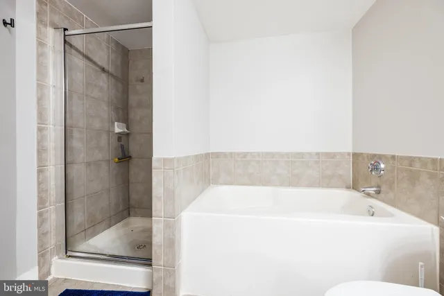 a bathroom with a granite countertop sink mirror vanity and toilet