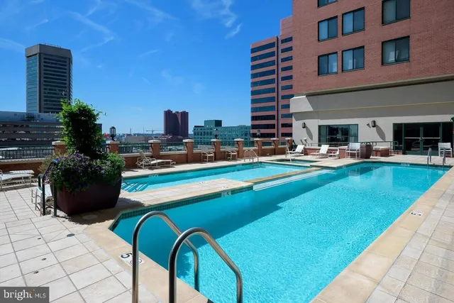 a view of a swimming pool with outdoor seating