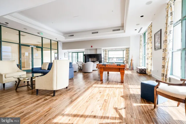 a view of a livingroom with workspace and a window