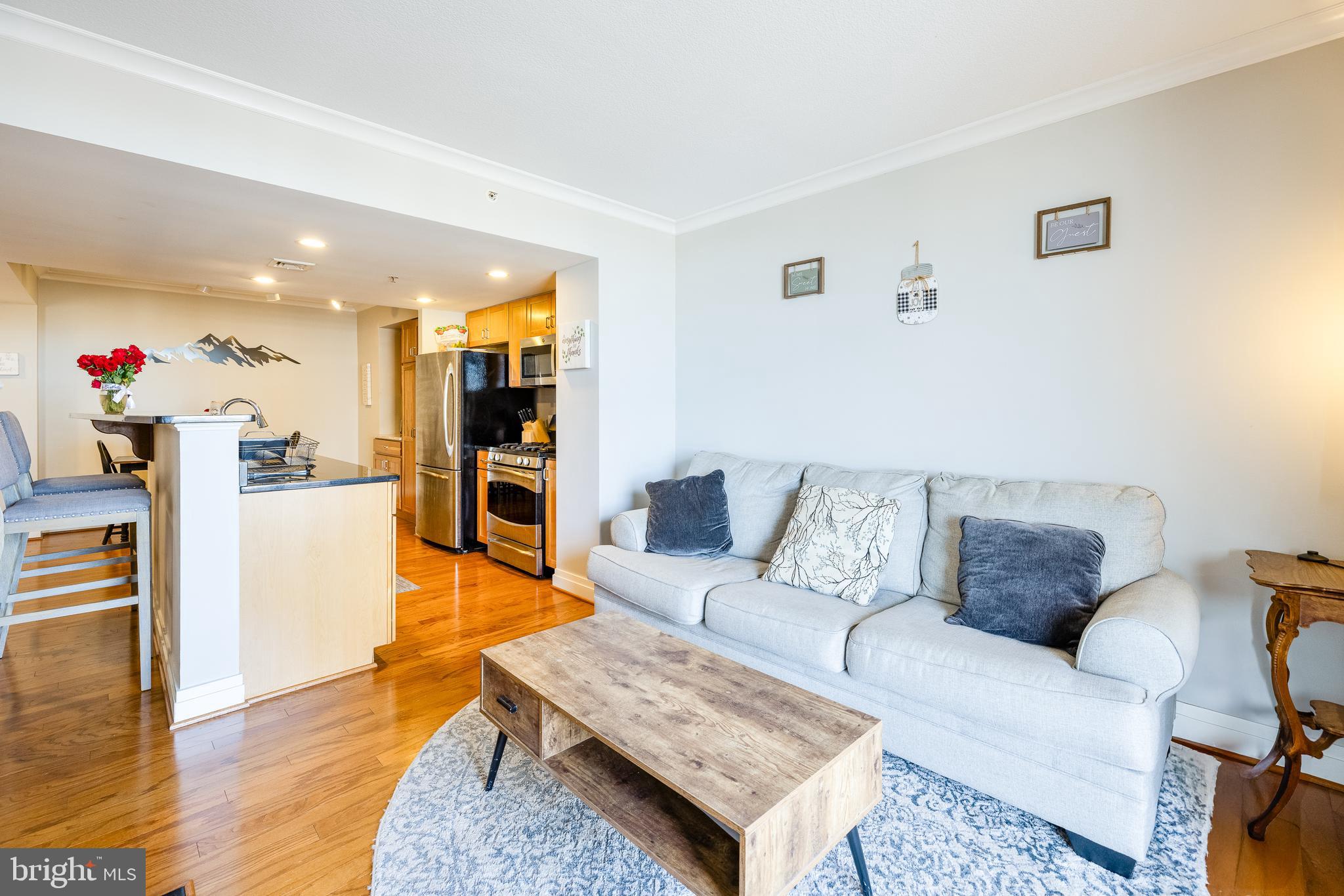414 Water Street, Unit 1108 Baltimore, MD 21202 - Photo 6 of 36 a living room with furniture and a wooden floor