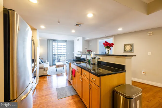 a kitchen with stainless steel appliances granite countertop a sink and cabinets