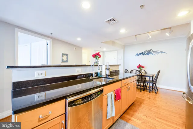 a dining room with furniture and kitchen view