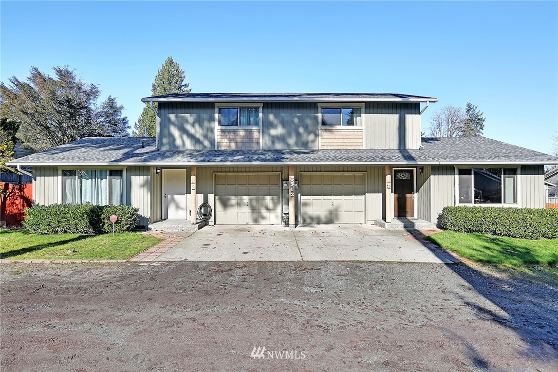 6513 Cady Road Everett, WA 98203 - Photo 1 of 11 a front view of a house with a yard and potted plants