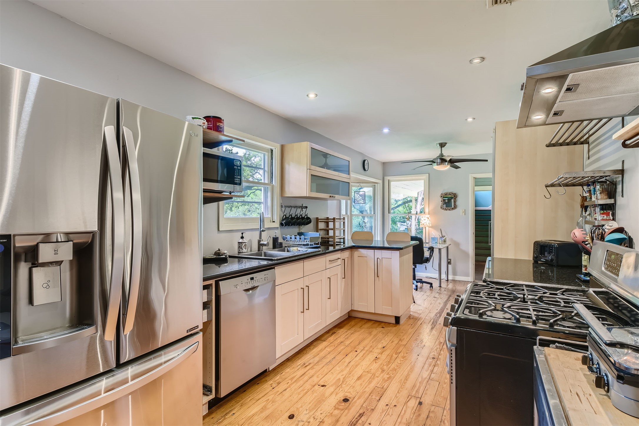 6804 Vine Street Austin, TX 78757 - Photo 5 of 15 a kitchen with stainless steel appliances granite countertop a refrigerator a stove and a sink