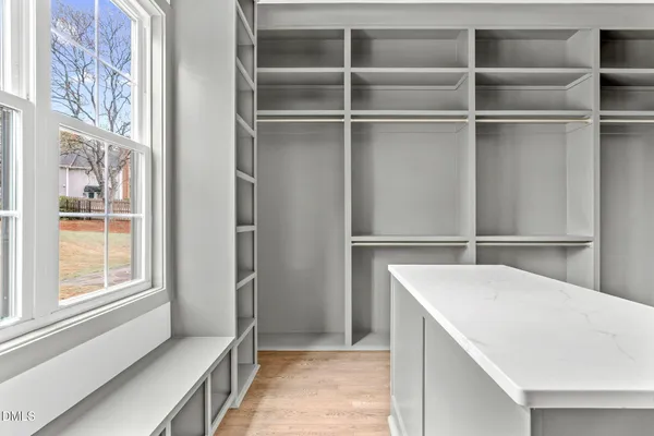 a spacious bathroom with a shower sink and mirror
