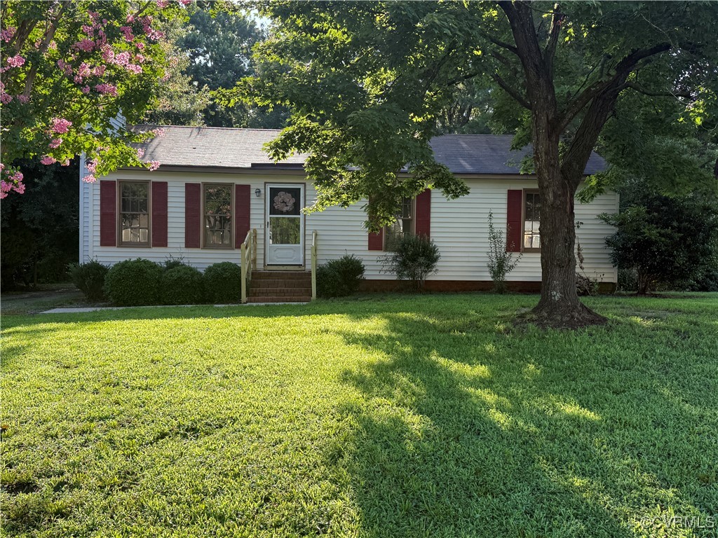 a view of a house with a yard and tree