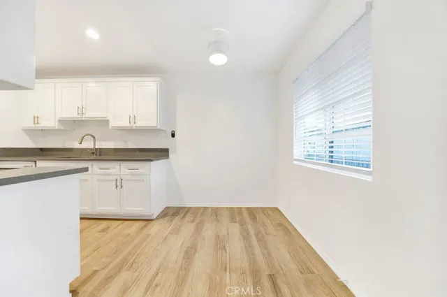 a kitchen with a sink window and cabinets