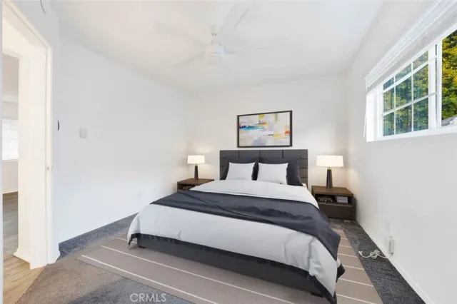 a bedroom with a bed and window