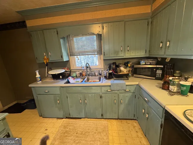 a kitchen with stainless steel appliances granite countertop a refrigerator a stove top oven a sink and dishwasher