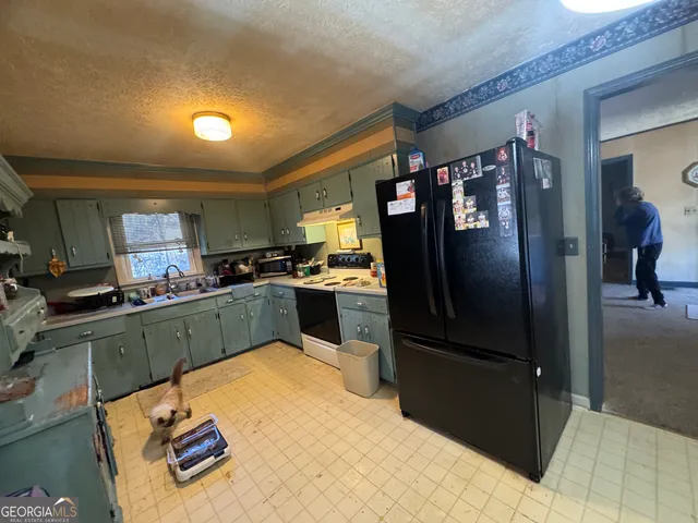 a balcony with furniture and paintings on the wall