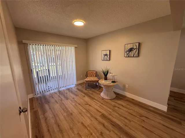 a view of a bedroom with wooden floor