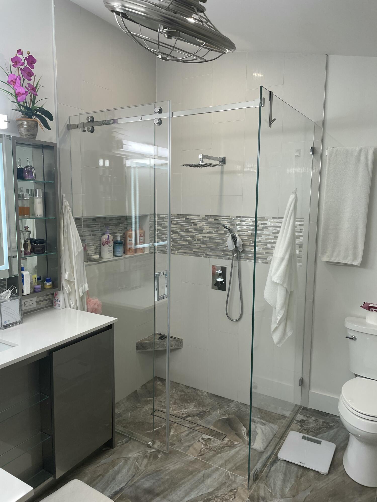 22305 Whistling Pines Lane Boca Raton, FL 33428 - Photo 12 of 16 a bathroom with a granite countertop sink a toilet and shower