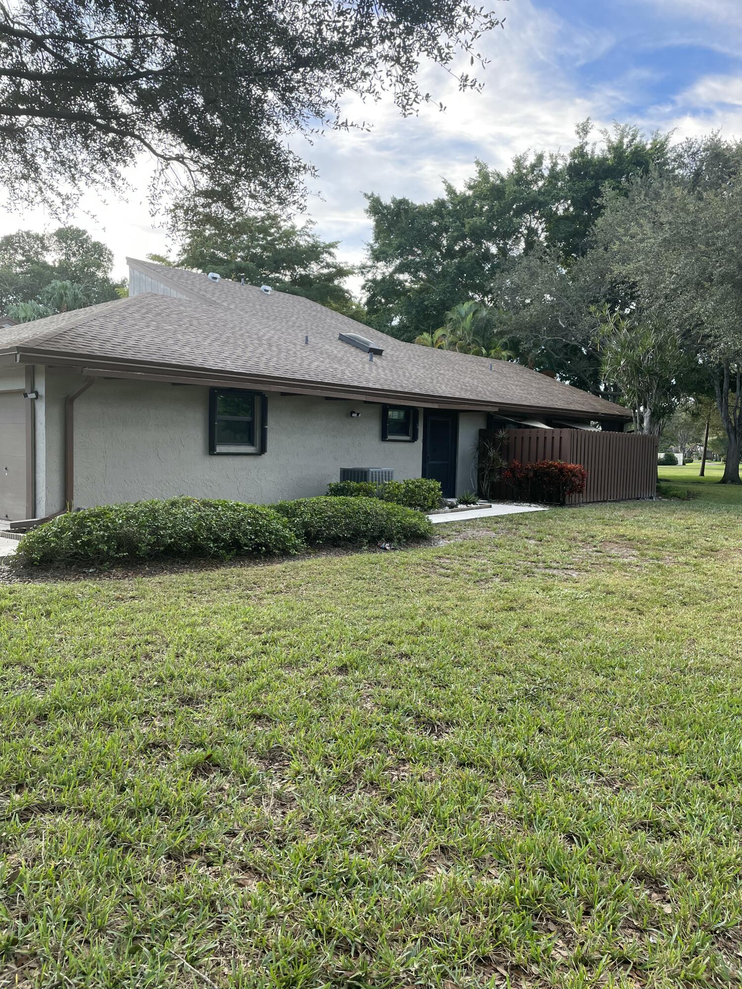 22305 Whistling Pines Lane Boca Raton, FL 33428 - Photo 3 of 16 a house view with a garden space