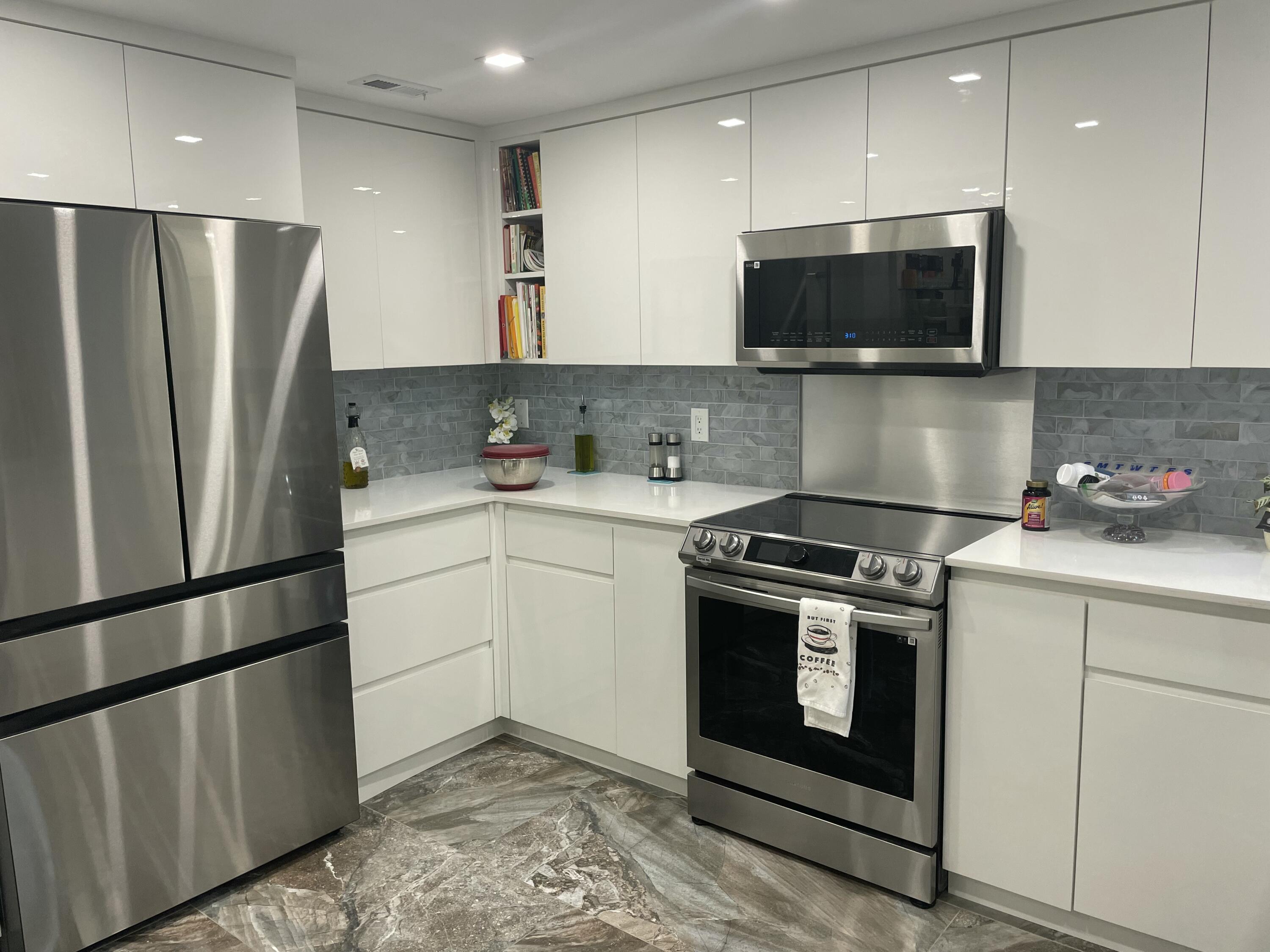 22305 Whistling Pines Lane Boca Raton, FL 33428 - Photo 7 of 16 a kitchen with a sink stove and refrigerator