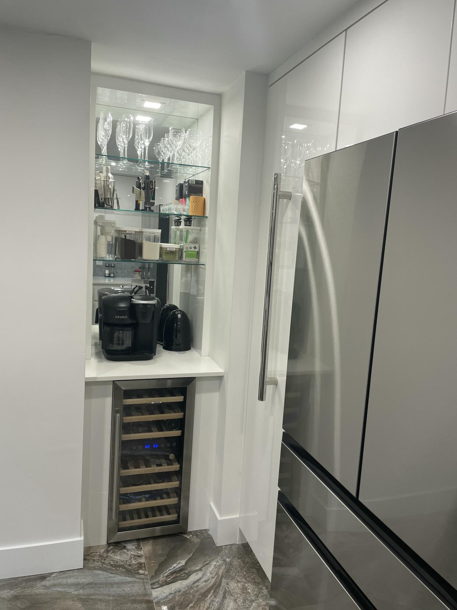 22305 Whistling Pines Lane Boca Raton, FL 33428 - Photo 8 of 16 a kitchen with a refrigerator and a floor