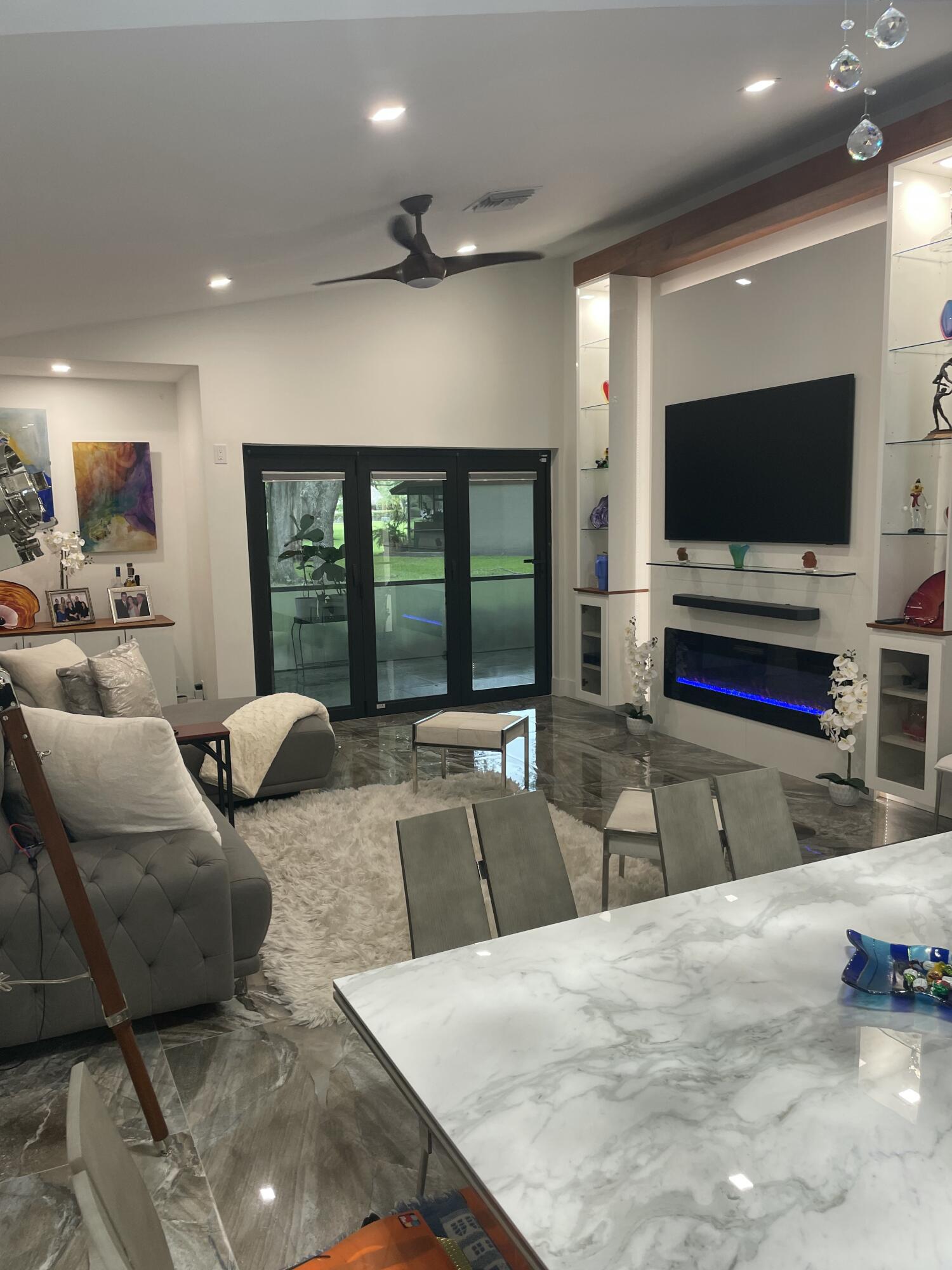 22305 Whistling Pines Lane Boca Raton, FL 33428 - Photo 9 of 16 a living room with furniture and a flat screen tv