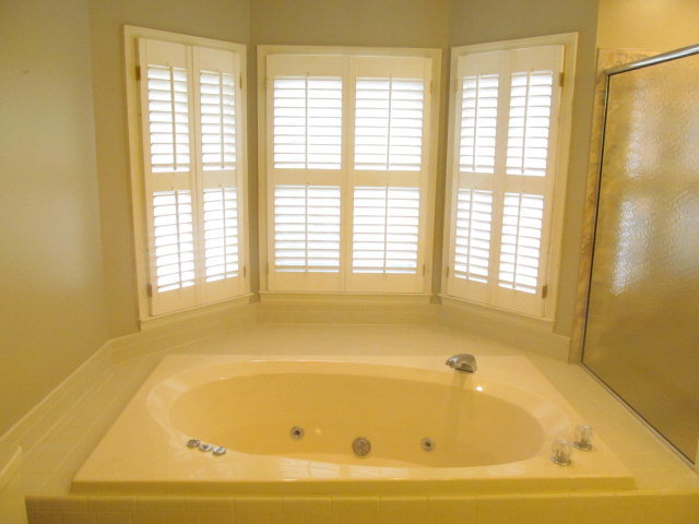 5016 Hartley Bridge Road Macon, GA 31216 - Photo 17 of 27 a bathroom with bathtub and window